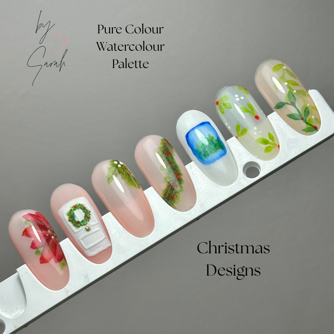 Nail art display with Christmas designs on a gray background, featuring the brand 'Pure Colour Watercolour Palette'.